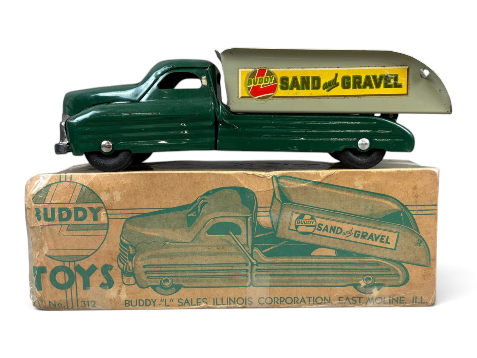 Buddy L Sand & Gravel Truck #312 with Original Box: Pressed steel truck, approx. 13" long. Shows some edge/corner wear and light surface wear. Original box is included, box is shrink wrapped, however shows wear with tears, creases, etc. One end of the 