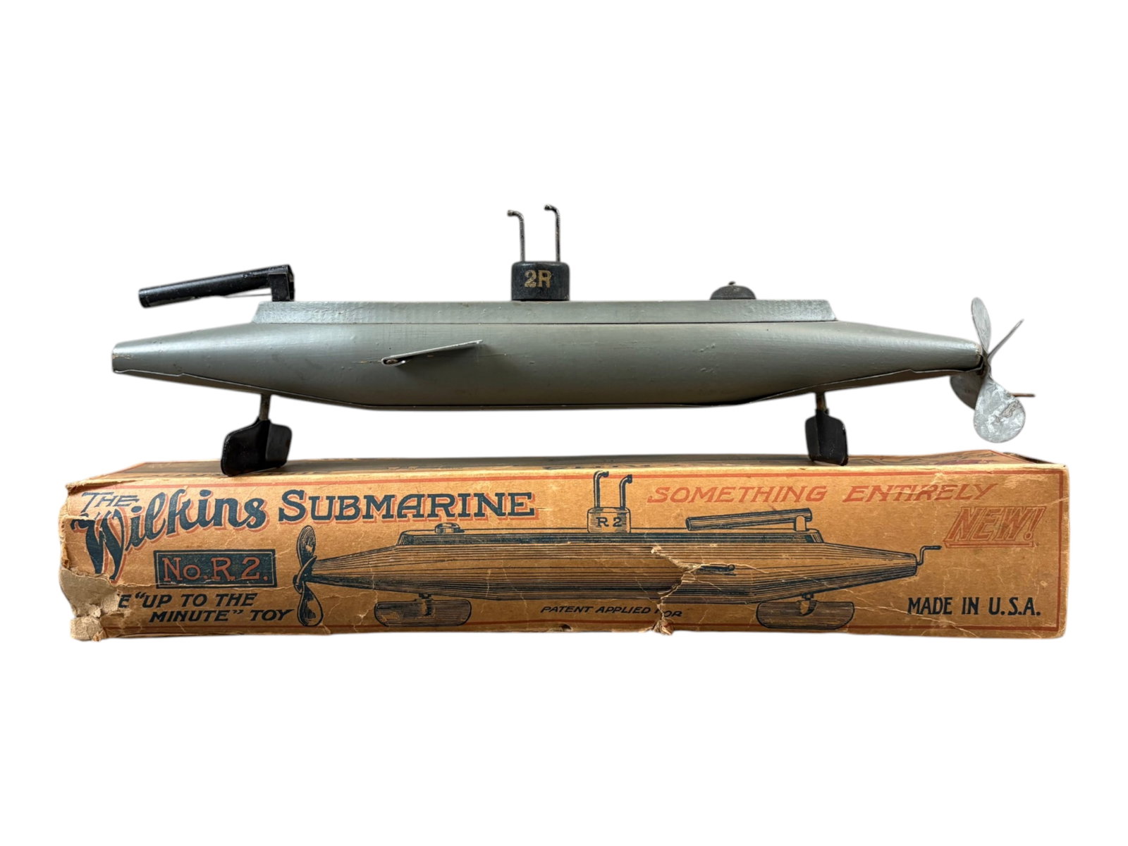 Boxed Wilkins R2 Submarine: Early wooden submarine toy. Overall approx. 15" long. All original. Comes in the original box which is rough and shows overall wear throughout with tears, creases, torn missing end flaps, etc. Shippin