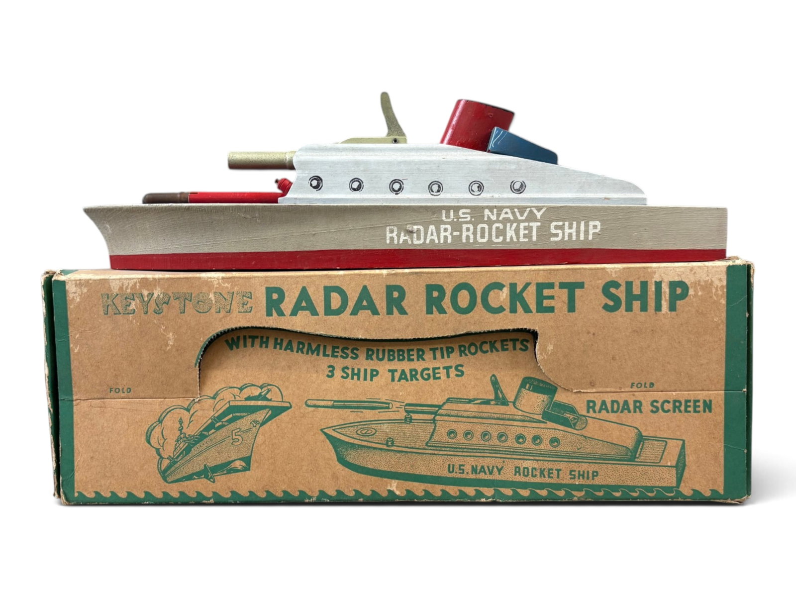 Boxed Keystone Wooden US Navy Radar Rocket Ship: Circa 1940's, Keystone #255 Wooden Radar Rocket Ship with original box. Missing the target ships, and includes 2 out of 3 rockets. Approx. 14" long. Shows some playwear with surface scuffs, etc. Origi