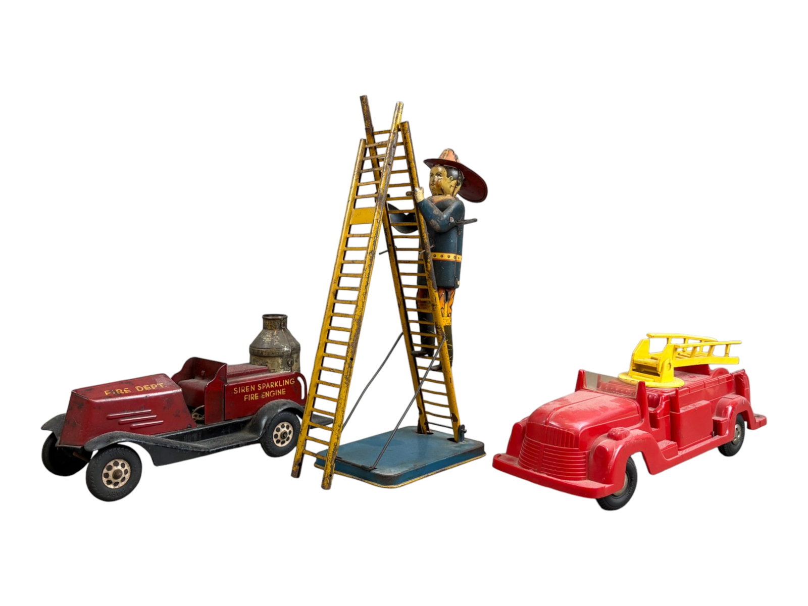 3 Piece Fire Truck and Toy Lot incl. Marx: 3 pieces. Includes Marx friction powered Siren Sparkling Engine (9-1/2"), Marx plastic fire engine, incomplete (12"), and tin litho Climbing Fireman toy. All show overall playwear with paint loss, scu