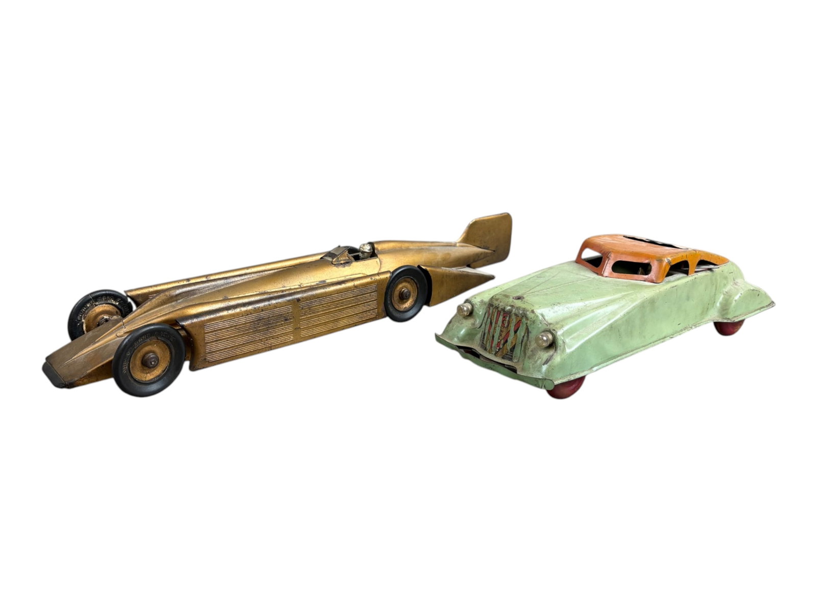 2 Pc Tin Litho Cars, Kingsbury Golden Arrow, Etc: 2 piece lot. Includes Kingsbury Golden Arrow Racer, approx. 20" long, wheels show damage, and another tin litho pull chain sedan (14"), missing hood ornament. Both show overall wear with paint loss,