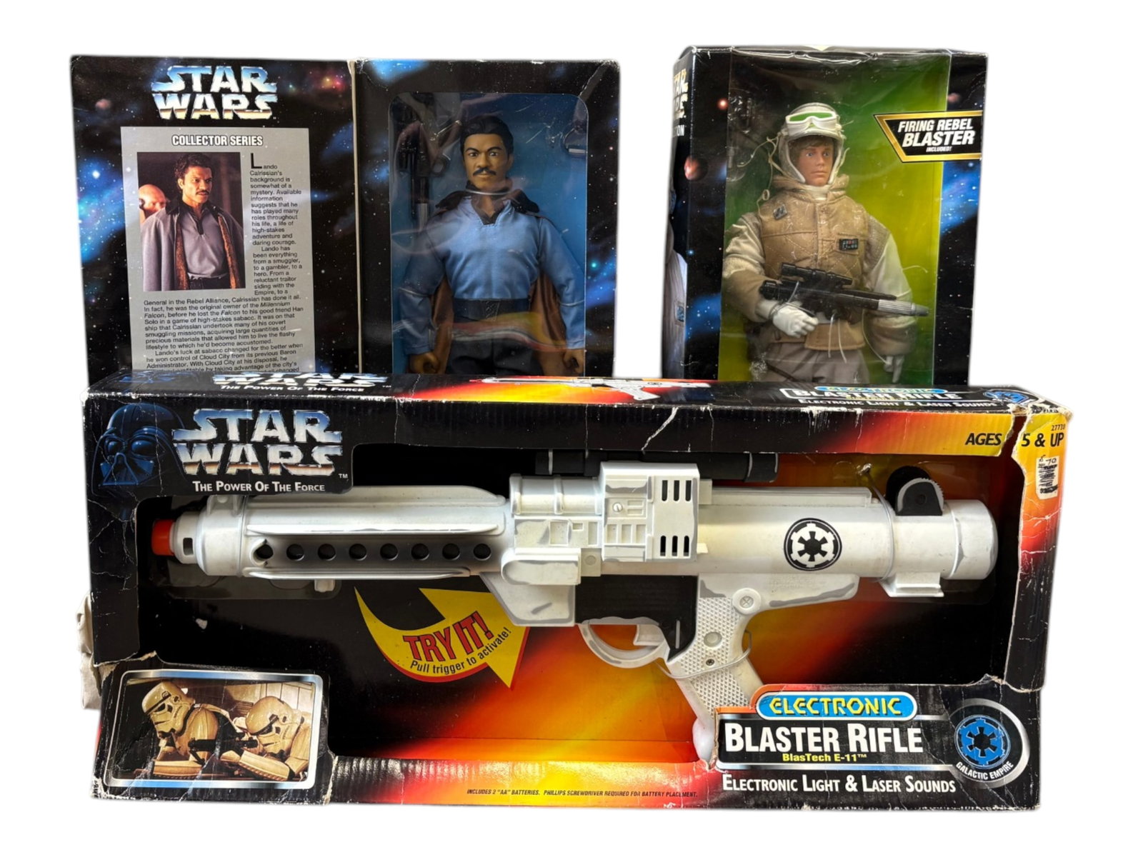 (3) Piece Modern Star Wars Toy Lot: Includes Star Wars Power of the Force Electronic Blaster Rifle, 12" Luke Skywalker in Hoth Gear, and Collector Series Lando Calrissian. Boxes all show overall wear with tears, creases, surface wear, e