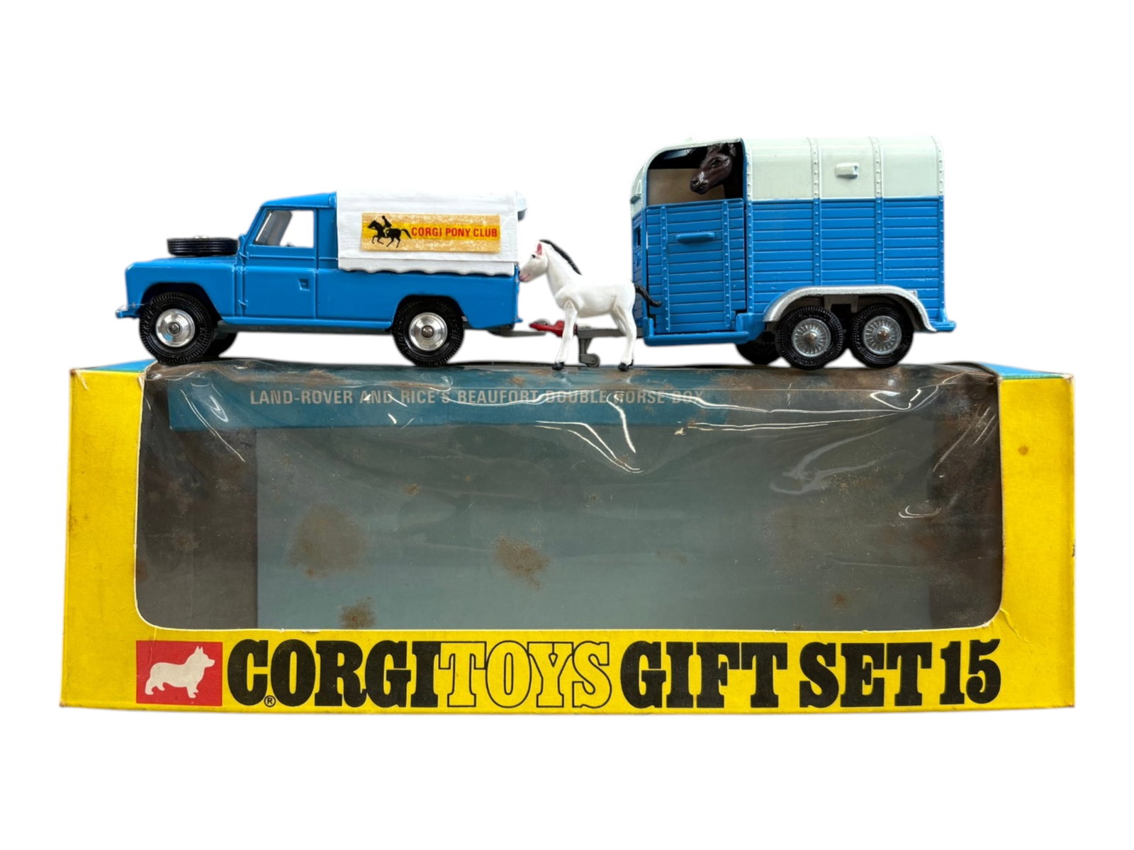 Corgi Toys GS15, Land Rover with Horse Box Trailer: Features Land Rover with detachable canopy, Rice's Beaufort Double Horse Box, and Mare. Missing foal. Shows light playwear. Comes in the original box which shows some wear, staining, tears, etc.