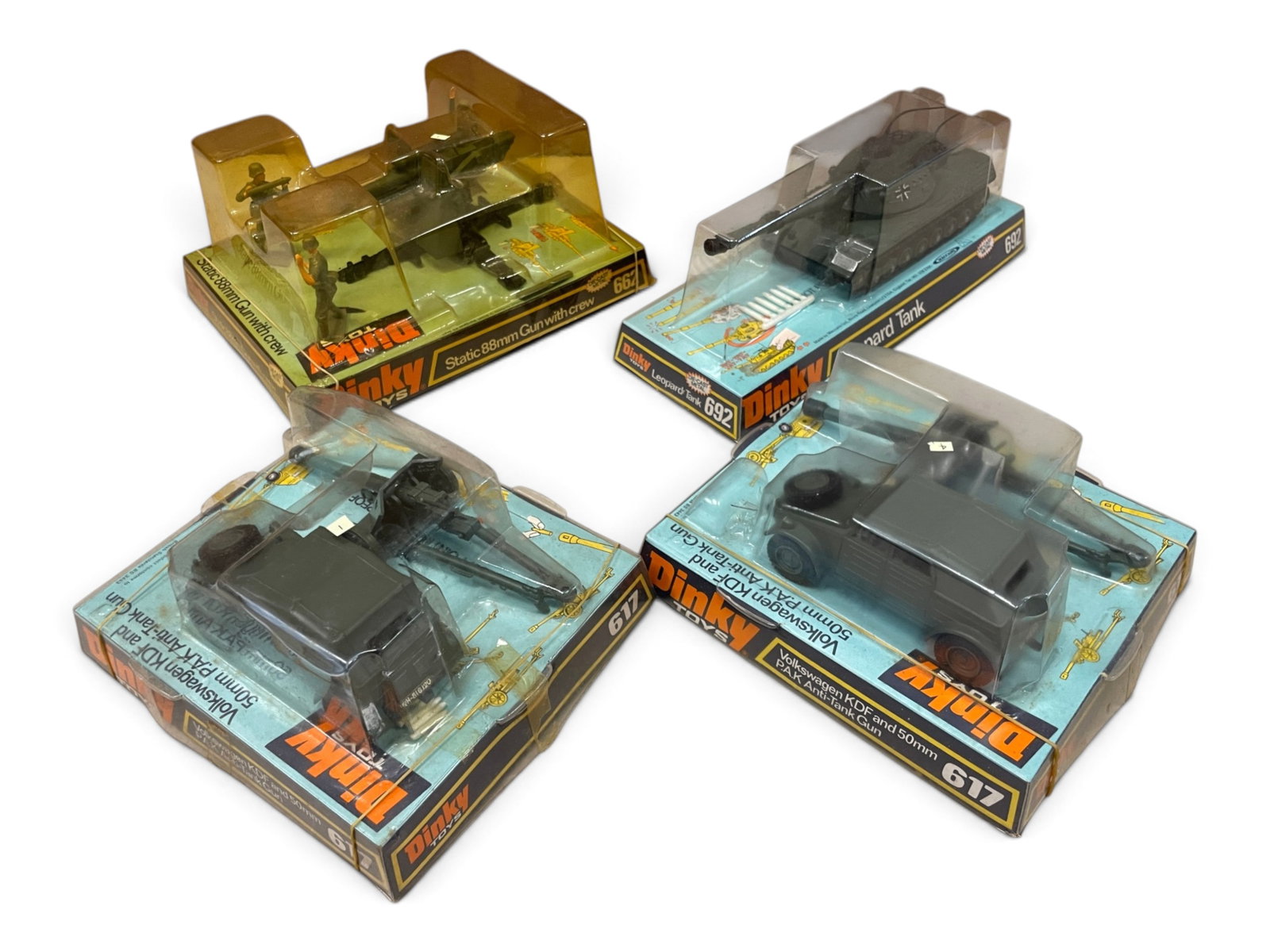 4 Boxed Dinky German Military Vehicles: Includes a 662 Static 88mm Gun with crew; 692 Leopard Tank; 2-617 VW KDF with PAK Anti-Tank Guns; They appear like new with packaging, 662?s top slightly yellowed. Shipping: Weiss Auctions offers