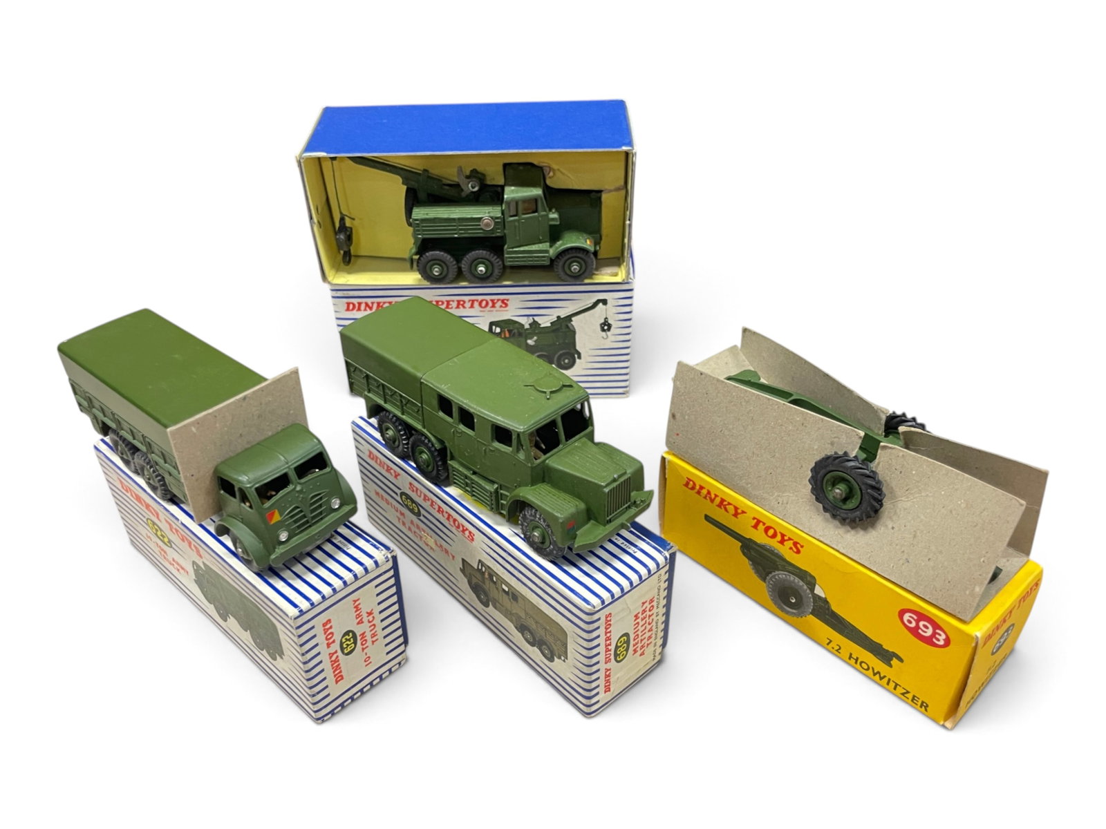 4 Boxed Dinky Miltary Vehicles: Includes a 661 Recovery Truck with hook & line, both box inserts; 689 Medium Artillery truck; 693 7.2 Howitzer with insert; 622 10-Ton Army truck. All show light handling with nice boxes. Shipping: