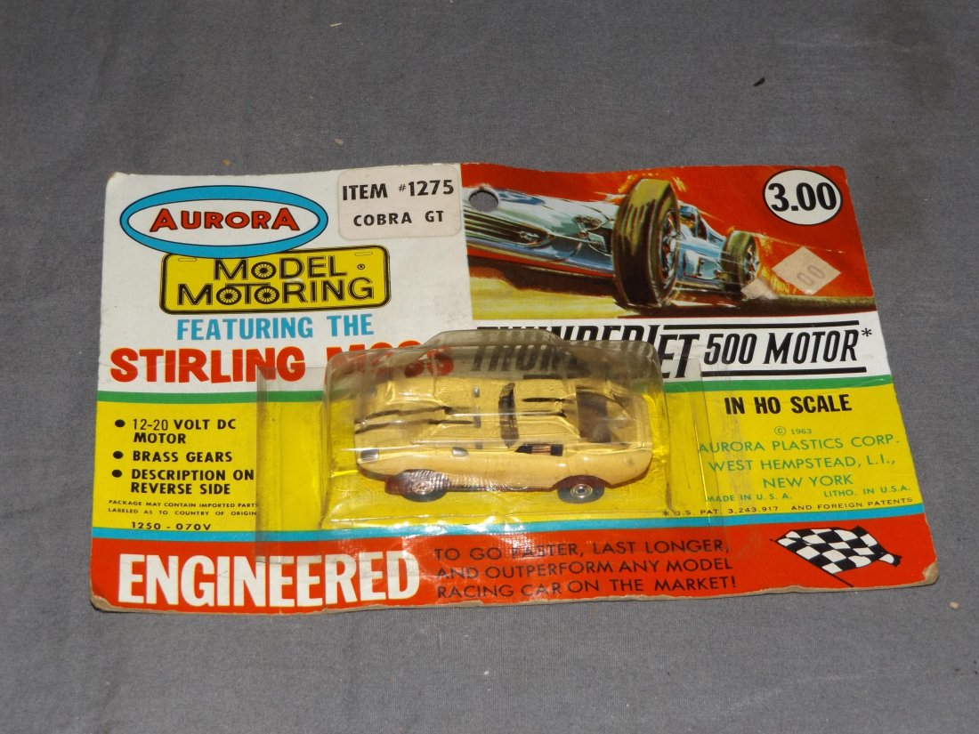 Aurora #1275, Cobra GT, New on Card: Thunderjet HO Scale. New on Card, Unopened. Card has some wear with creases, and light bubble dents.