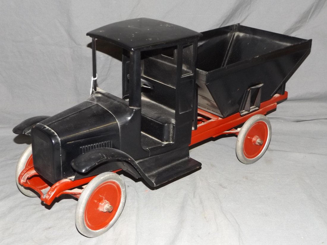 Buddy L Pressed Steel Coal Truck: Circa 1930's, pressed steel. Buddy L Coal Truck. Doorless black cab, red chassis, black service body, with disc wheels. Approx. 25" long. Appears to be repainted.