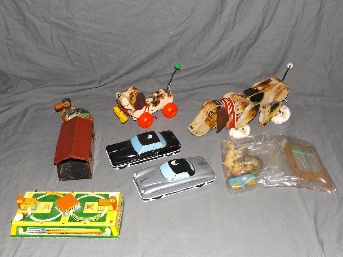 Mixed Toy Lot: includes Fisher Price Snoopy, Little Snoopy, car tins, tin garage. All show some wear.