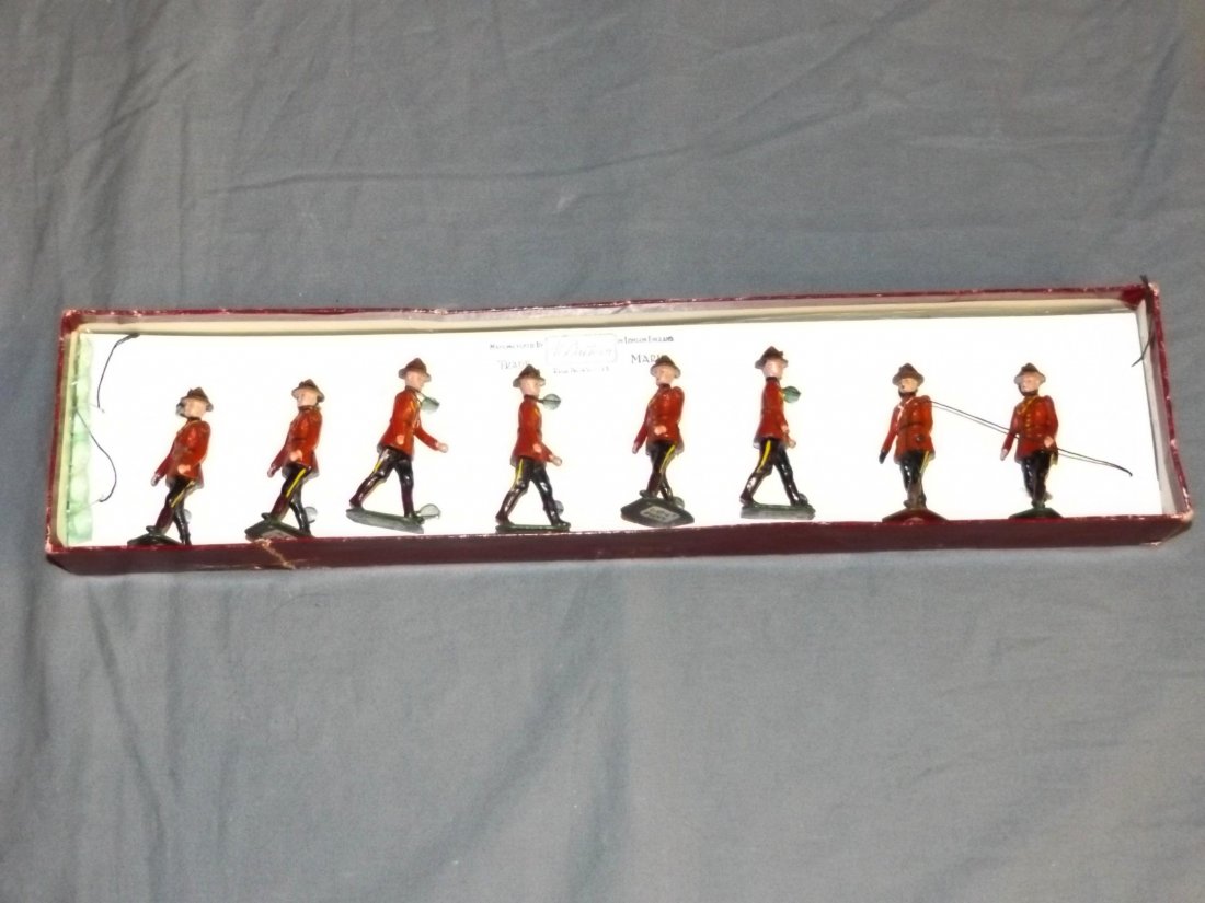 Britains #1554, Royal Canadian Police, Post War: 8 piece Infantry set. Post War version. Tied in. Box shows wear with tears, creases, etc. Box is not original, at the 2 pieces are mismatched.