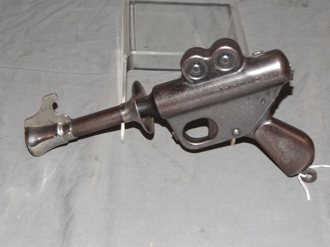 1930's Daisy Buck Rogers Pop Gun Pistol, Working: Vintage Buck Rogers Pop Gun Pistol by Daisy, circa 1930's. Approx. 10" long. Working condition. When trigger is pressed, a loud pop sound is made. Shows playwear with some paint scuffs, scratches, etc