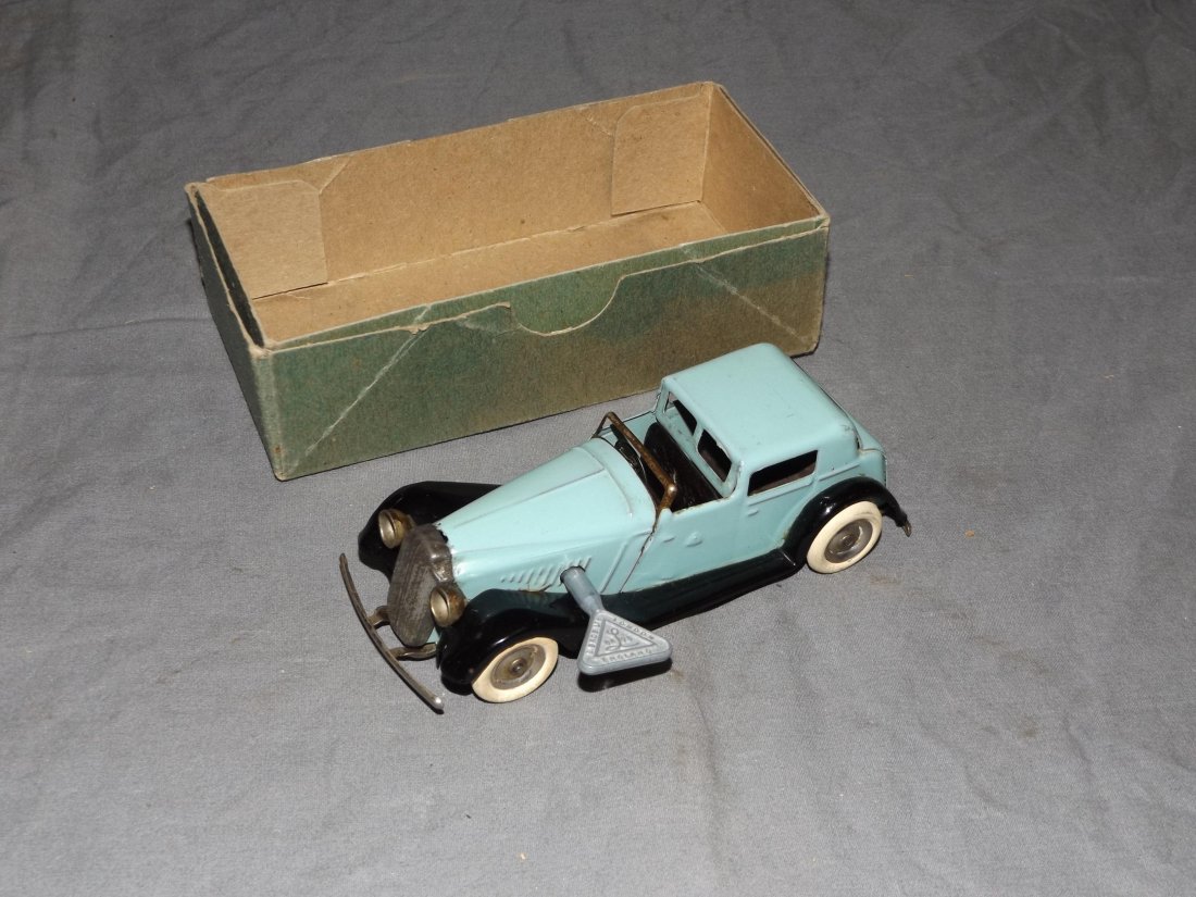 Windup Tri-Ang Minic Sedan: Working condition with original key. Box is not original. Approx. 5" long. Toys shows some wear with scuffs and scratches.