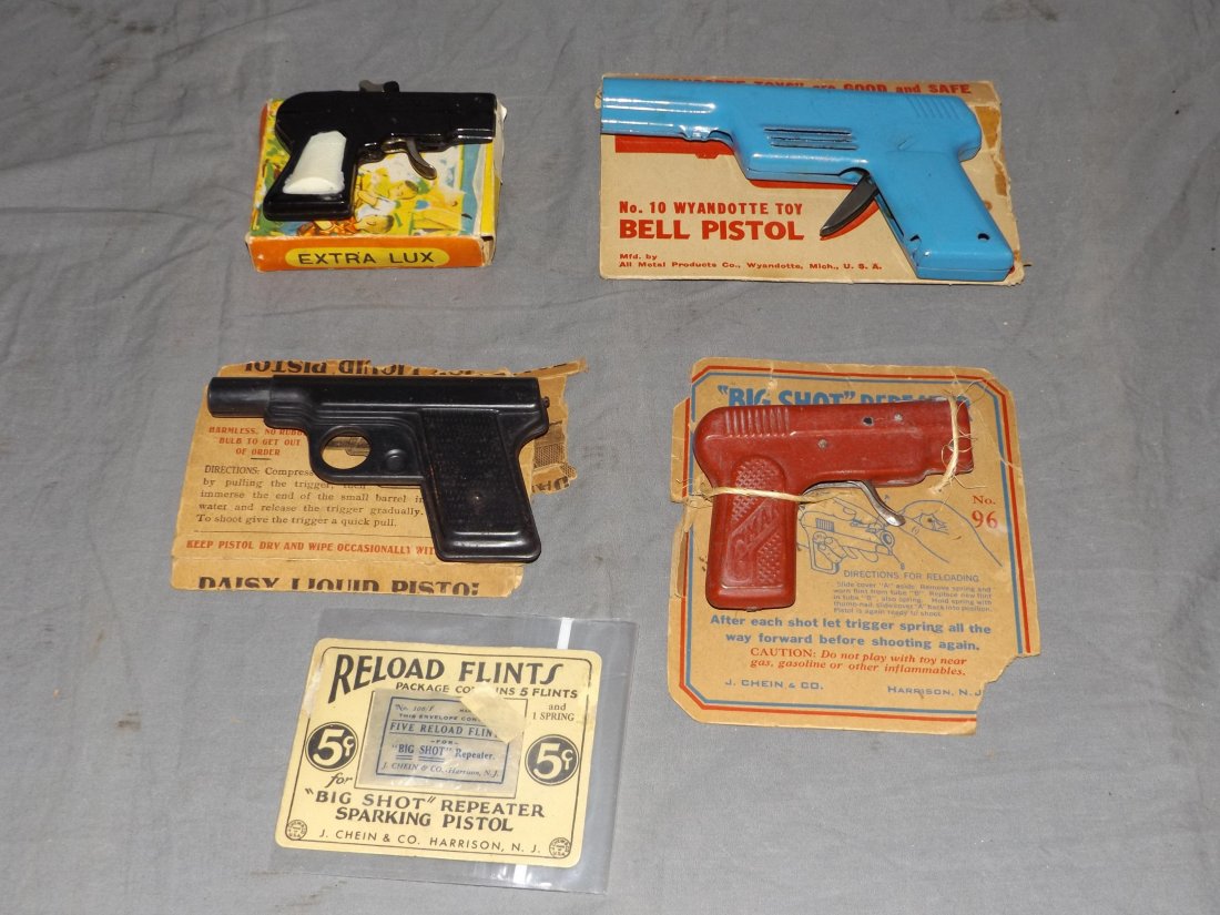 Lot of 4 Toy Pistols: Includes boxed Extra Lux, Chein Big Shot Repeater with extra flints, boxed wyandotte bell pistol, and Daisy liquid pistol. All show some wear with scuffs, scratches, etc. Boxes/packaging shows wear wi