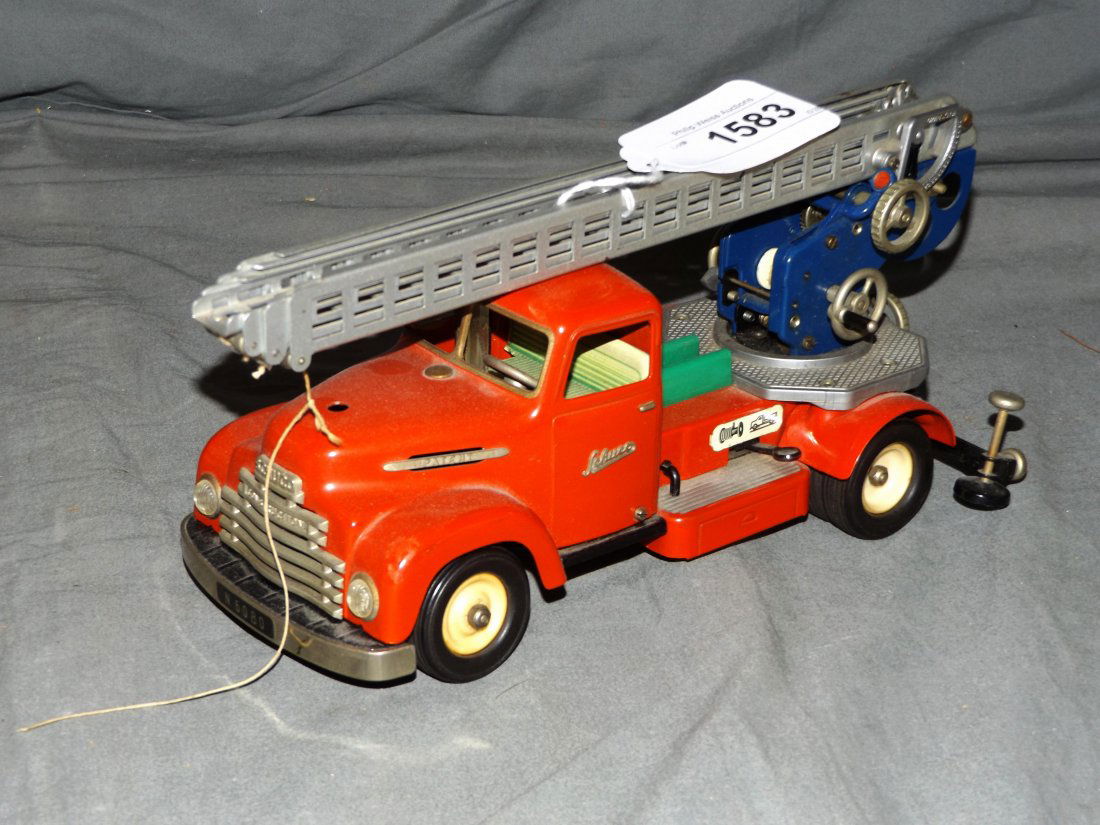 Schuco Tin Wind Up Fire Ladder Truck.: Made in Western Germany. Toy is all original with nice detail. Approx 11-1/2". Missing hood ornament. Some wear with light scuffs and scratches. .