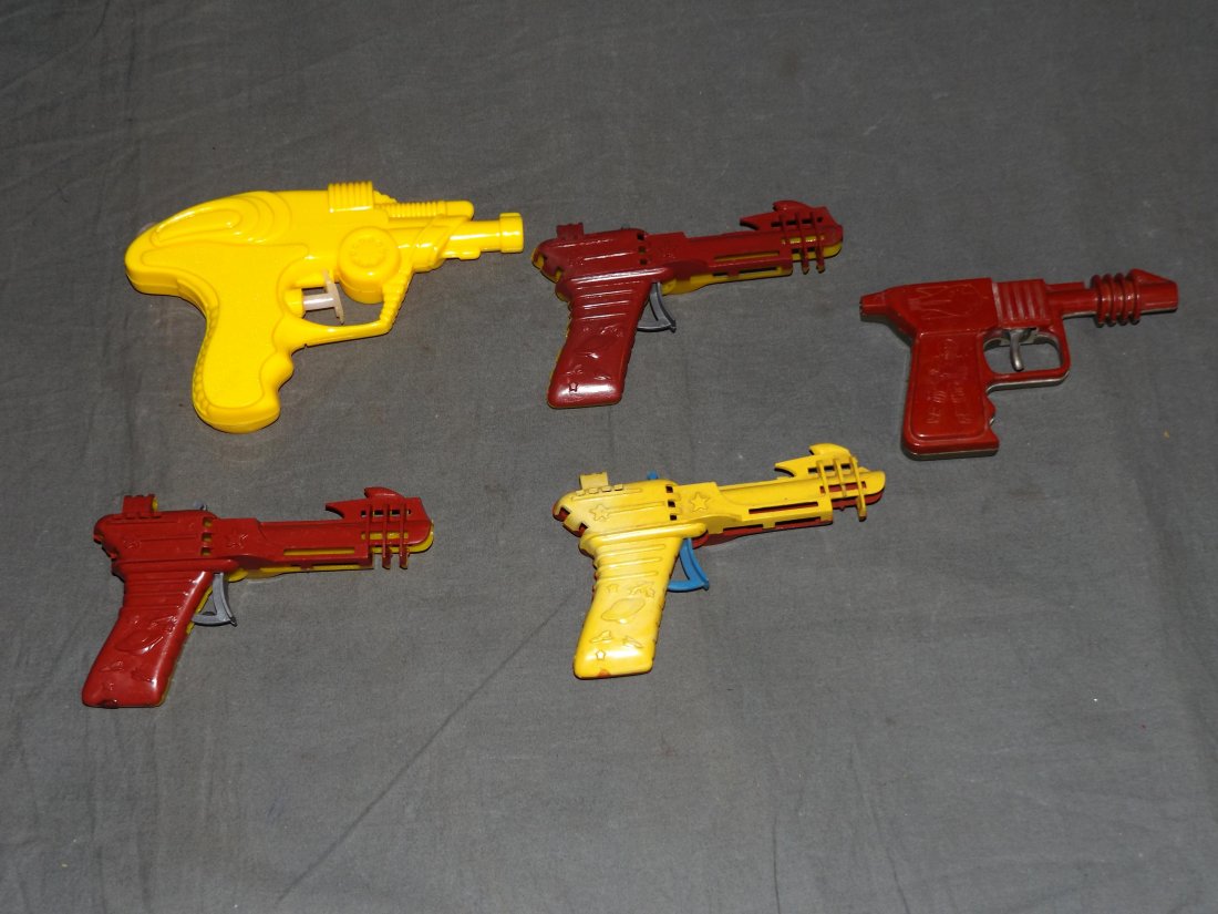 Lot of Vintage Plastic Space Ray Clicker Guns: Includes (3) Palmer Plastics space ray clicker guns, circa 1955, space ray gun water pistol, and another clicker gun. All clicker guns are in working condition. Each show some wear with scuffs and scr