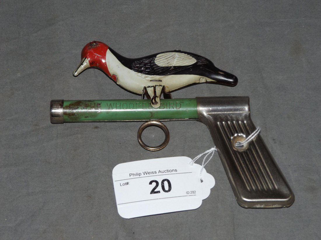 Rare Tin Litho Whoopee Bird Toy Gun: Approx. 6.5" long. Working condition. When trigger is pressed the bird acts as a woodpecker and makes a pecking motion on the barrel of the gun. Shows wear with some scuffs and scratches.