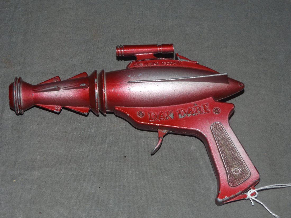 1960's Dan Dare Space Cap Gun, Lone Star Prod: Vintage Dan Dare Space Cap Gun by Lone Star Productions, circa 1960's. Approx. 7.5" long. Trigger is tight and not working. Shows playwear with some paint scuffs and scratches.