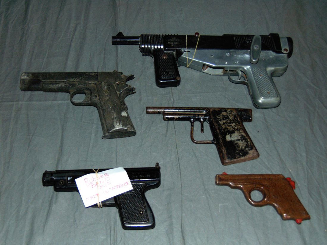Lot of Assorted Toy Guns: Includes ceramic gun, rubber band gun, (2) all metal guns, and Mattel toy machine cap gun. All show wear. Examine