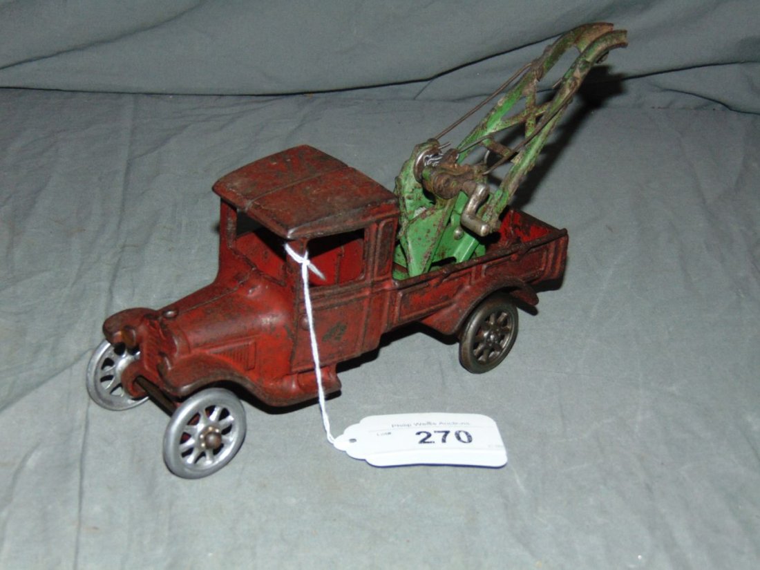 Cast Iron Arcade Tow Truck: Approx. 8.5" long. Missing nickel driver. Nickel spoke wheels. Wear throughout with scuffs, scratches, paint loss. Examine