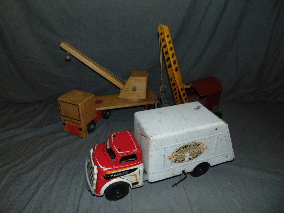 Box Lot of Assorted Toy Trucks: Includes Wyandotte Dept. of Public Service truck, Lincoln Construction Co. Crane, and wooden Creative Playthings. All show some wear with scuffs, scratches.