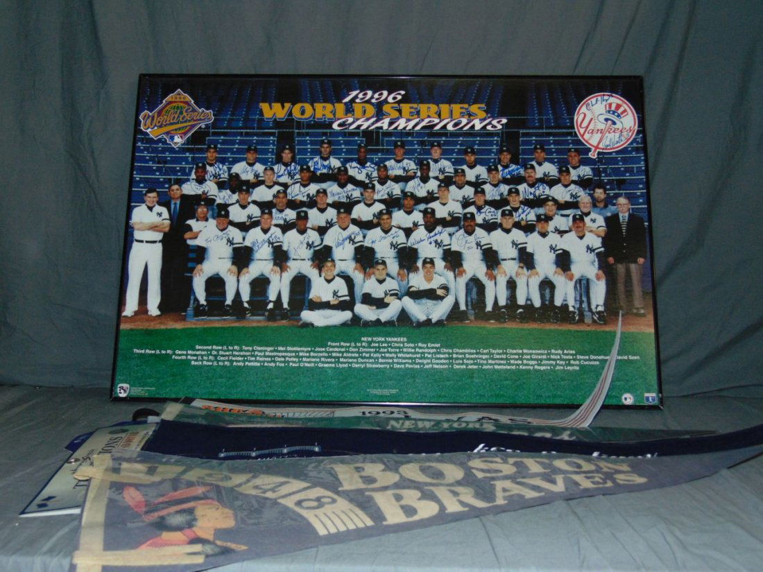 1996 Yankees Team Signed Print & Pennants: Lot consists of a team signed photo print of the 1996 New York Yankees with signatures including Pettitte, O'Neill, Strawberry, Torre, Stottlemyre, Boggs, Martinez, Williams, Rivera, Cone, and more. N