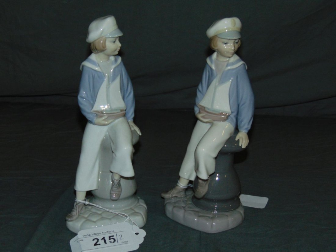 Llaadro Figurines. Lot of 2..: Lo of 2 Porcelain Figurines includes Boys with Sail Boats in hand. Different color shading to eacn. No chips or cracks noted. Examine.