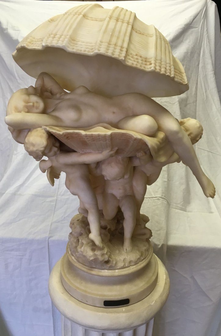 Eugenio Pattarino Alabaster Statue with Pedestal: Lot consists of a large and heavy Alabaster statue by Eugenio Pattarino. Depicts a nude woman laying in a shell, being held up by Puttis. Overall size with pedestal approx. 65" tall. Statue alone is a