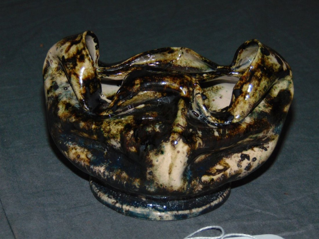 George Ohr Glazed Crimped Bowl: Glazed crimped bowl. Approx. 5" long x 3.5" high. Signed on the bottom.