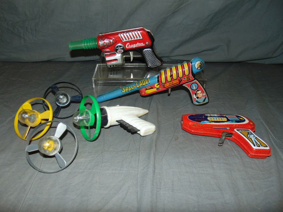 (4) Tin Lithographed / Plastic Space Toy Guns: Includes Space Cadet gun, Sparking Jet Ray Gun, Cragstan Machine Gun Ray Gun (not working), and plastic space propeller gun with 4 propellers. Some wear to each with scuffs and scratches.