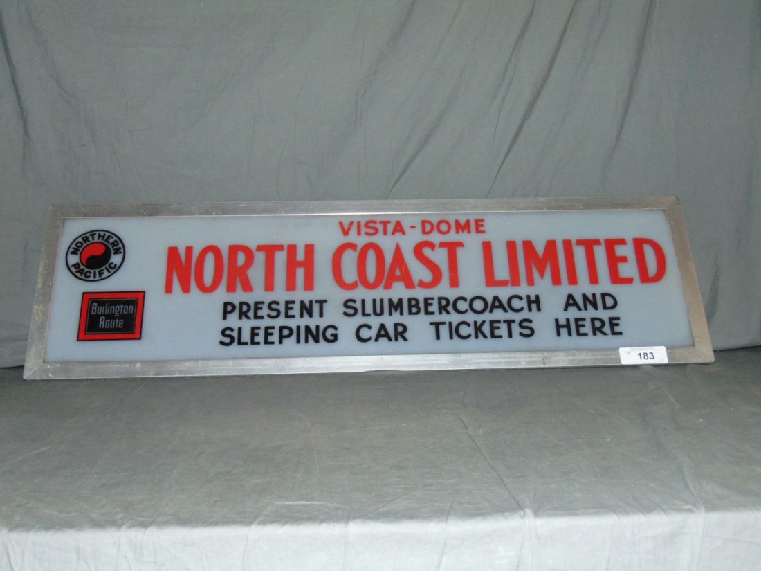 Northern Pacific & Burlington Route Depot Sign: Vintage Northern Pacific and Burlington Route Destination Depot Sign. "North Coast Limited". Approx. 38" x 11". Plexiglass sign in metal frame. Some surface scuffs and scratches. Small crack lower lef