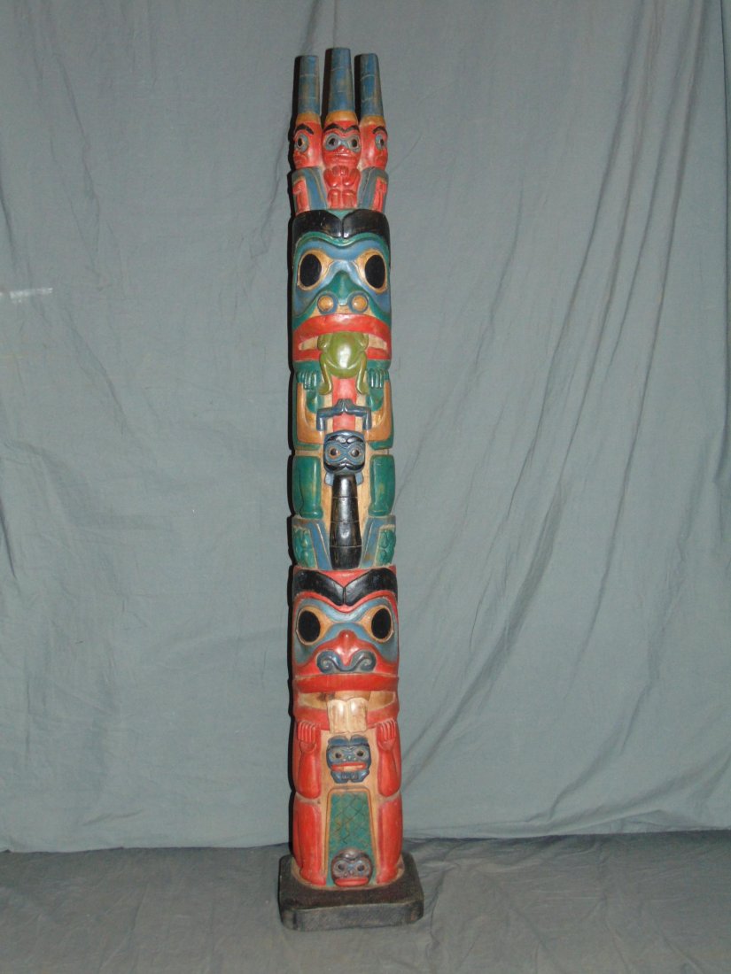 Totem Pole.: 46 1/2" tall wooden totem on base,