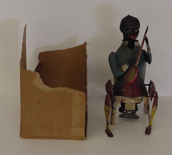 RARE. GERMAN TIN LITHO WIND UP BLACK BANJO.: APPROX 7" IN HEIGHT, SHOWS A BLACK MAN SITTING DOWN PLAYING A BANJO, TOY APPEARS TO WORK.SOME PAINT LOSS. EXTREMELY SCARCE.