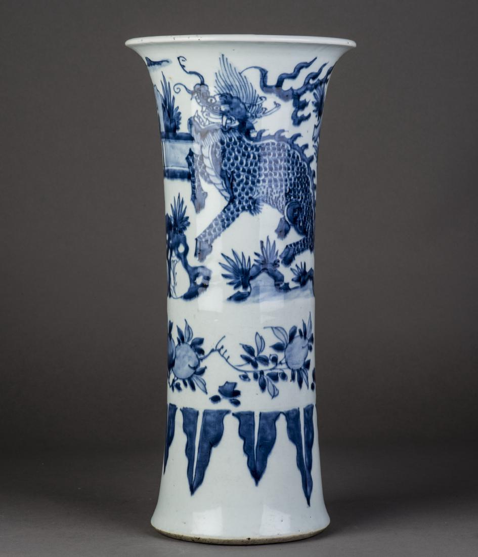 A CHINESE BLUE AND WHITE BEAKER VASE: Decorated with Qilin amongst rock and plantain trees landscape, the lower section with a band of plantain floral leafy above lappets band, no mark on base. Height 16'' Diameter 7.5''