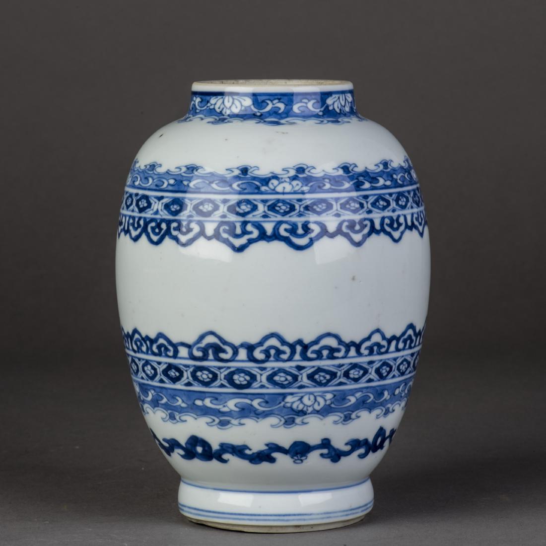 A CHINESE BLUE AND WHITE BALUSTER VASE: Decorated with bands of stylized archaistic motifs, scrolling flowers and foliage, lappets all between the baluster body as separator design, encircled by aÂ doubleÂ line border on base rim. Heigh