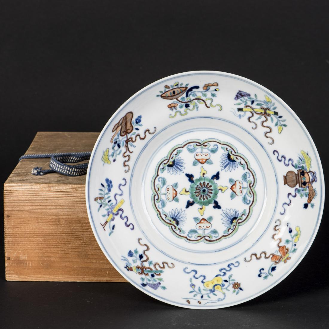 A DOUCAI OGEE-FORM BOWL DISH, QING GUANGXU PERIOD: Painted in the center of the interior with a flower head with overlapping petals enclosed by a conjoined scroll border incorporating peaches and stylized flower heads, encircled by the anbaxian, the e