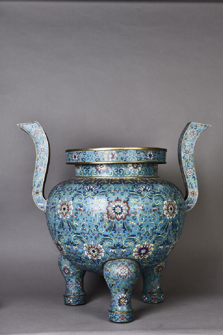 A CLOISONNE ENAMEL TRIPOD CENSER, QING DYNASTY: The censer is flanked by upswept handles and is raised on three cabriole legs that supports the body which is decorated around the sides with Eight Buddhist Emblems 'bajixiang' surrounded by flower sc