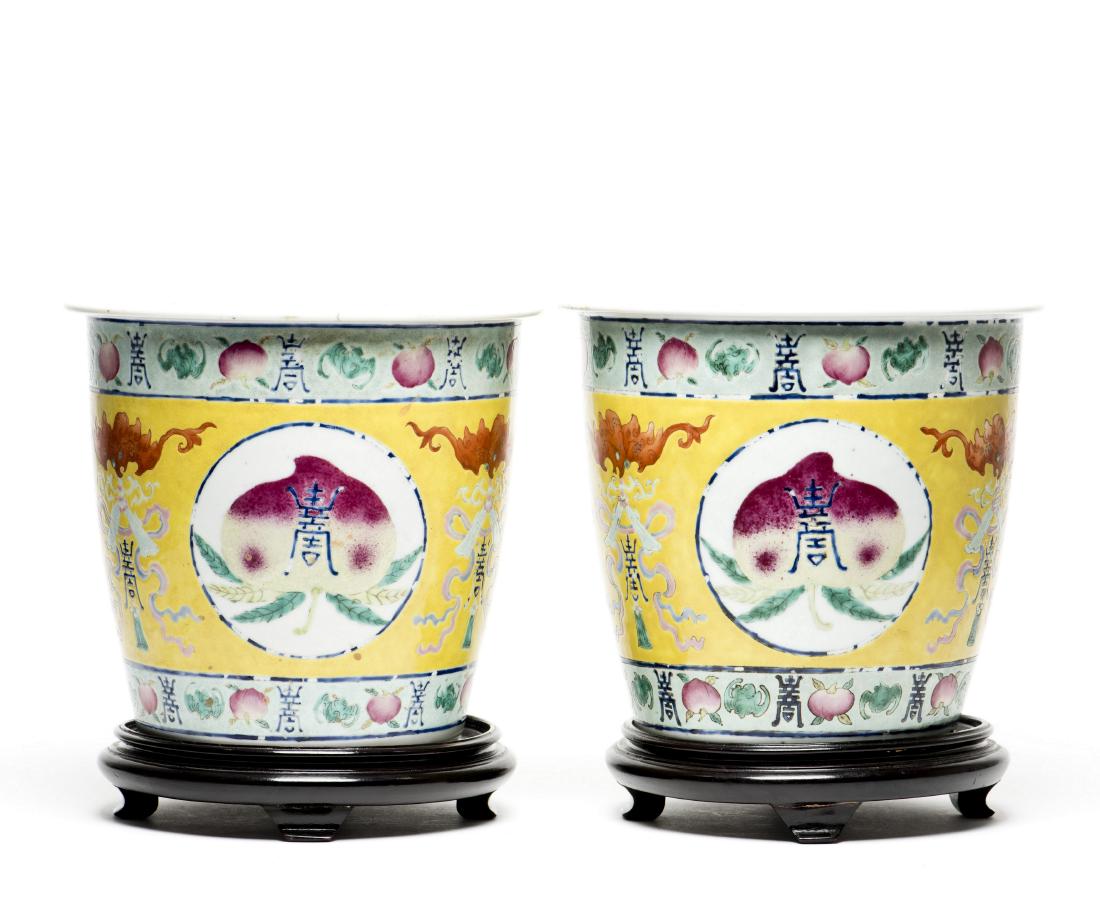 A PAIR OF FAMILLE ROSE PEACH POTS: Well potted with longevity bats and peaches depicted in different stages of ripeness ranging in color from light yellowish green to rose-pink deepening to darker pink spots and patches, on yellow grou