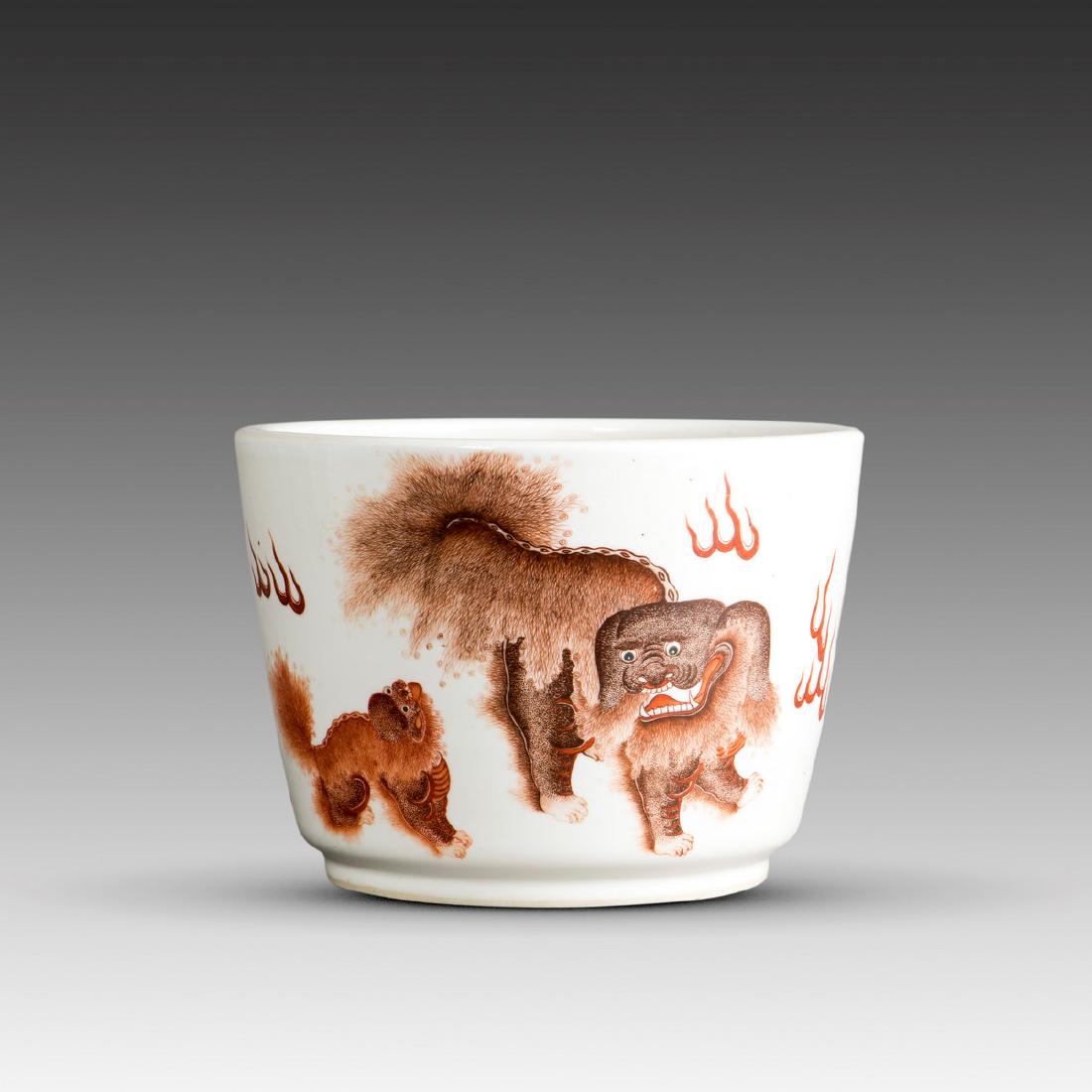 A CHINESE IRON-RED 'LION' JARDINIERE, TONGZHI PERIOD: The deep jardiniÃ¨re is decorated on the exterior in iron-red with two lions and fire scrolls, Ming dynasty. PROVENANCE: From a private collector in San Francisco. 17.5 x 24.5 cm