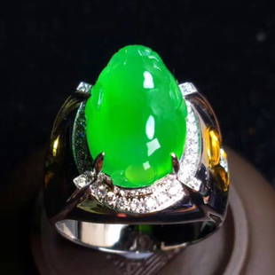 AN IMPERIAL GREEN, JADEITE RING, GIA CERTIFICATE: Set with an oval jadeite cabochon, within a pear-shaped diamond surround, mounted in 18k white gold, accompanied by GIA Certificate.