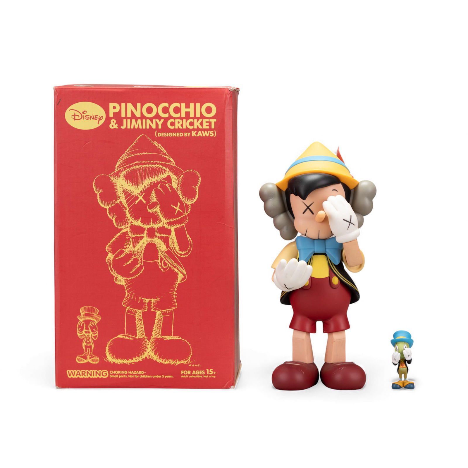 KAWS (Brian Donnelly), Pinocchio & Jiminy Cricket, with Original Box: KAWS (Brian Donnelly), Pinocchio & Jiminy Cricket, with Original Box. The complete set of two painted vinyl cast multiples, 2010, each with the artist's name, date, fabricator and collaborator printed