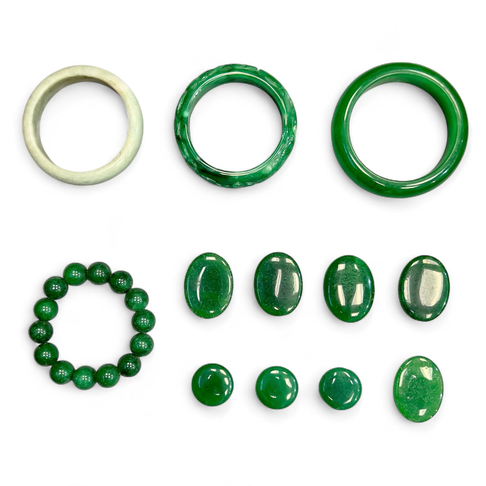 Group of Jade Jewelries: (lot of 12) Group of Jade Jewelries. Bracelet: 3.15"d (8 cm) (x1) Bracelet: 2.83"d (7.2 cm) (x2) Beaded bracelet: 2.83"d (7.2 cm) (x1) Jade piece (oval): 1.57"h x 1.18"w (4 x 3 cm) (x5) Jade piece (ro