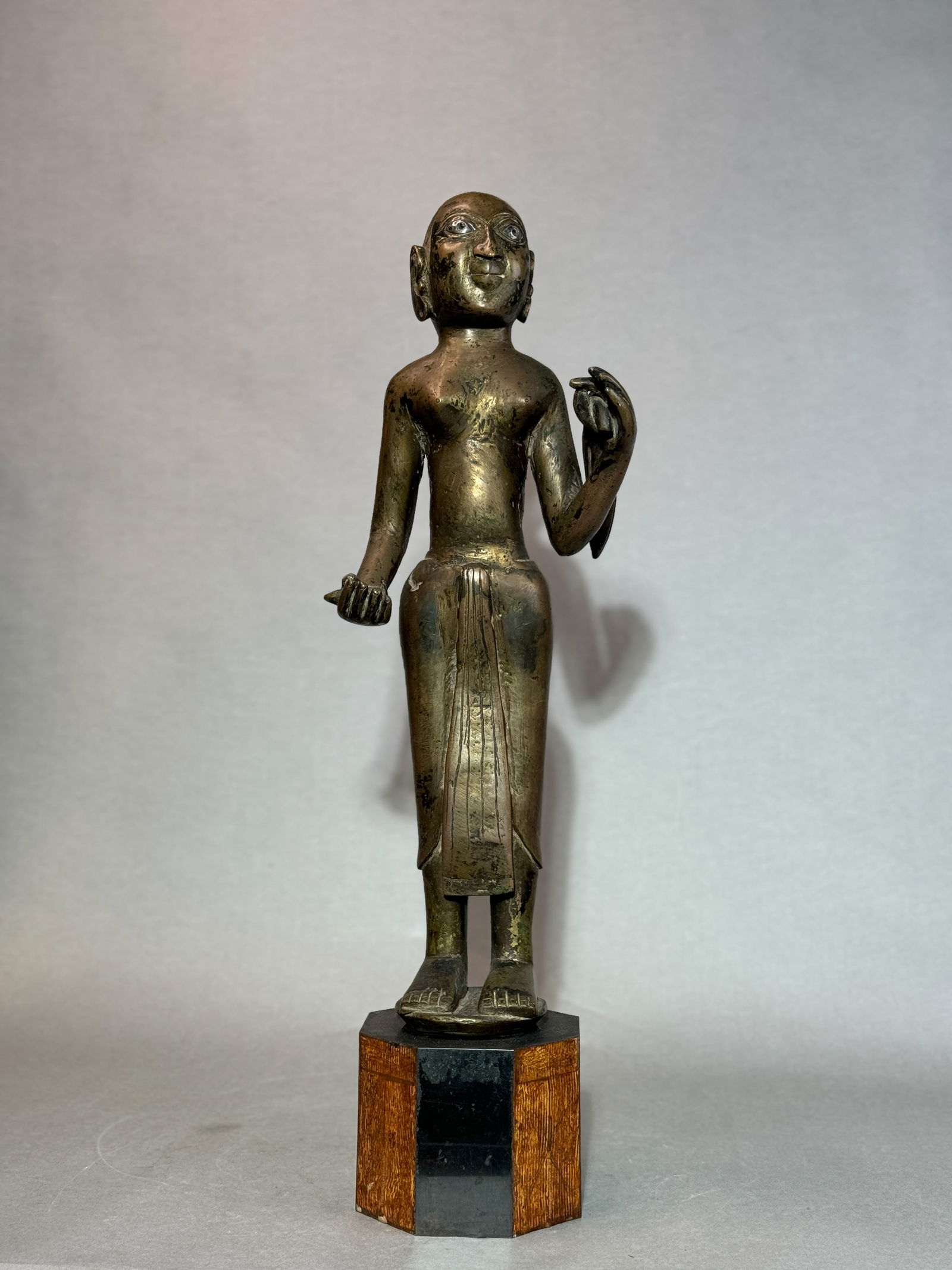 ANTIQUE INDIAN BRONZE FIGURINE WITH SILVER INLAY EYE: Antique Indian bronze figurine with silver inlay eye, 18th/19th century. Very heavy, solid bronze. Dimensions: Figurine Height: 19.25 in. On base: 23.5 in. Note: This item is in New York, where it can