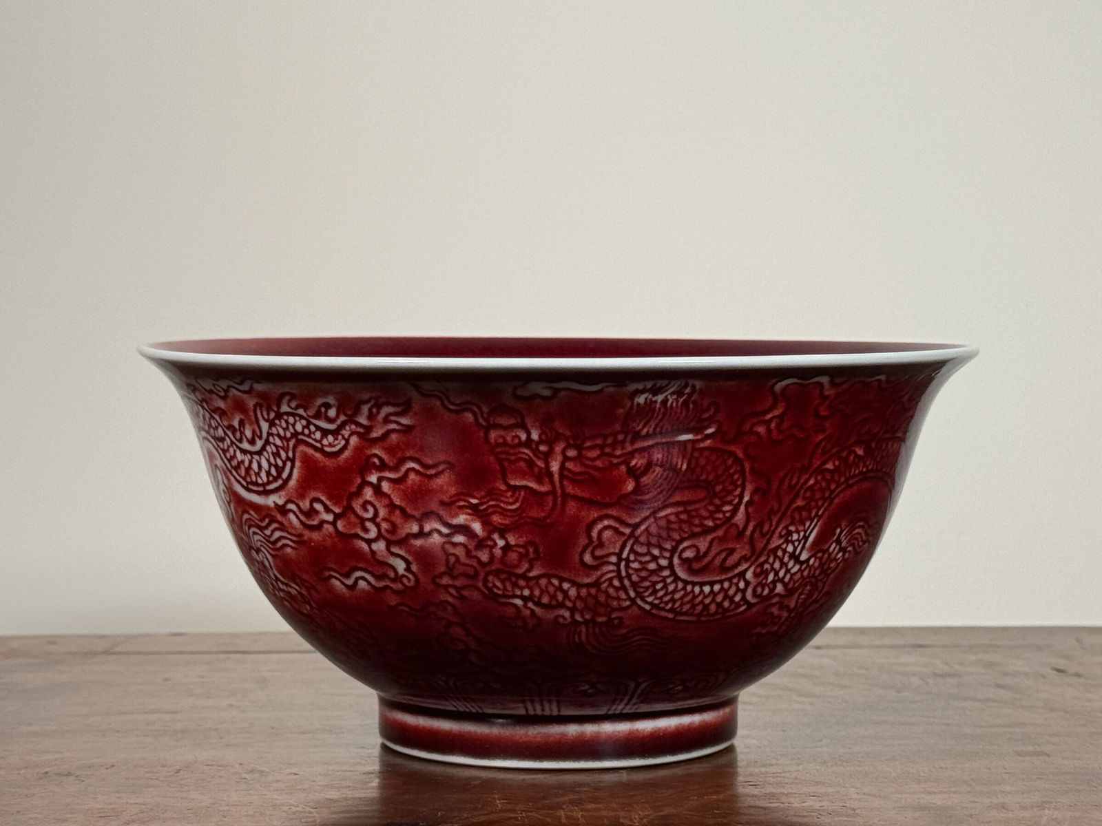 CHINESE OXBLOOD PORCELAIN BOWL WITH DRAGON: Chinese oxblood porcelain bowl with incised dragon motif. Dimensions: Diameter: 8 in. Height: 3.75 in. Note: This item is in New York, where it can be shipped from.