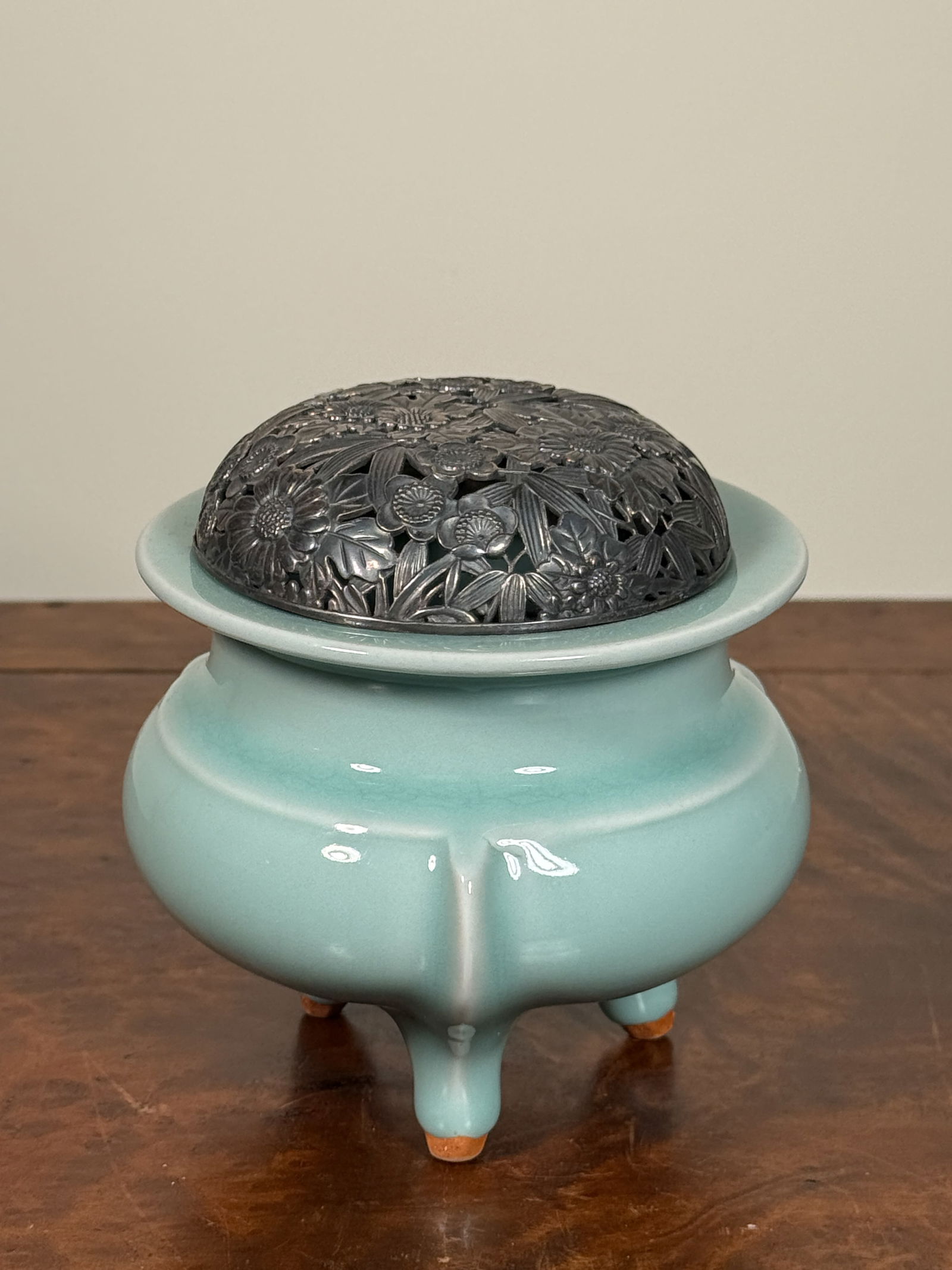 JAPANESE CELADON PORCELAIN CENSER WITH SILVER LID: Japanese studio porcelain censer of Celadon glaze, silver lid, impressed mark Shuzhan. Dimensions: Diameter: 4.5 in. Height: 4.25 in. Note: This item is in New York, where it can be shipped from.