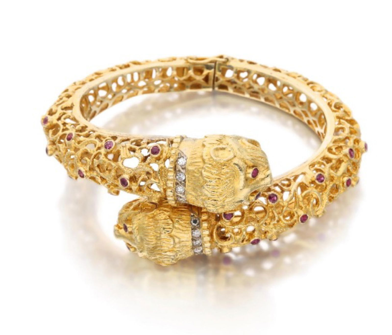 DOUBLE-HEADED CHIMERA BRACELET: A double-headed Chimera bracelet crafted from 18K gold. The piece is set throughout with rubies (approx. 2.70 ct total) and features diamond accents (approx. 0.20 ct total) along the necks of the two