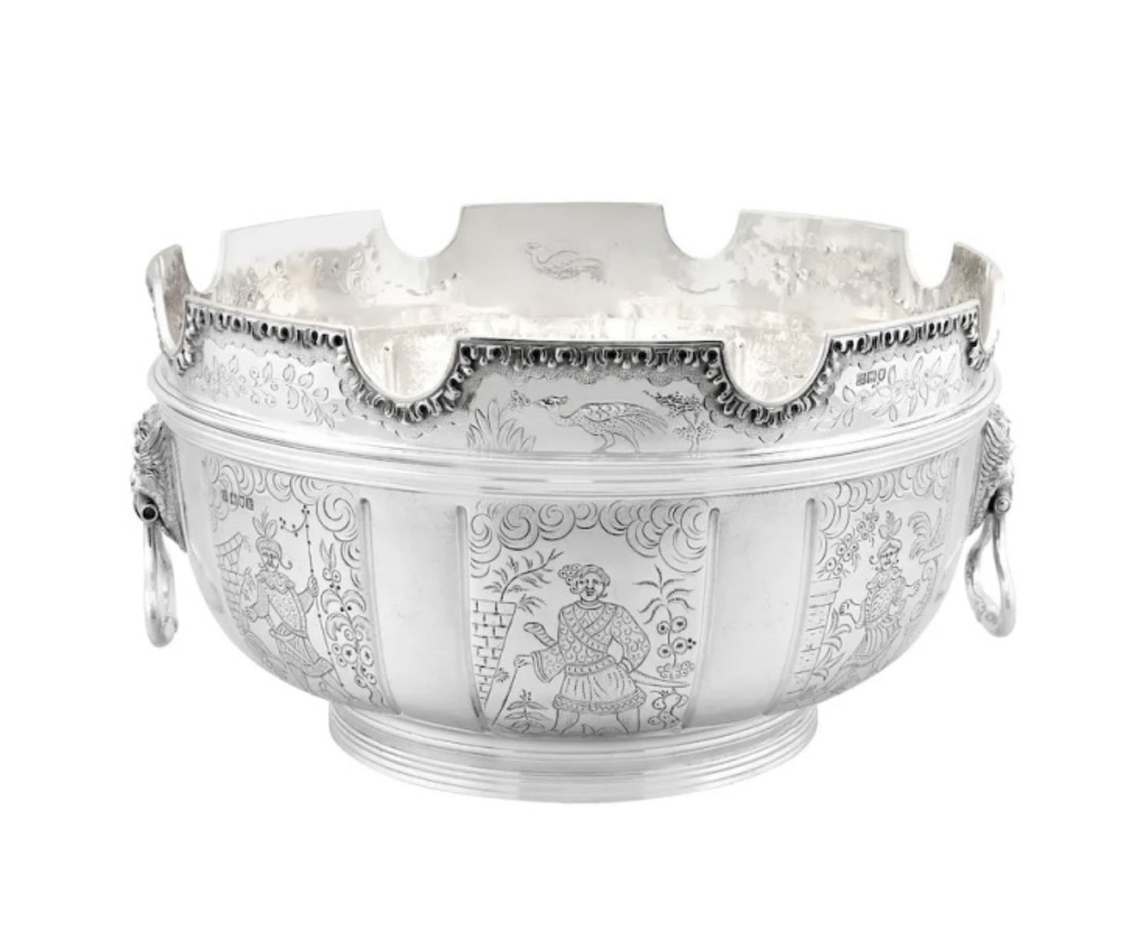 STERLING SILVER MONTEITH BOWL: This sterling silver bowl features a large Monteith style design with a distinctive notched rim. It incorporates lion head drop ring handles on both sides and a half-fluted body.Dimensions:Diameter: