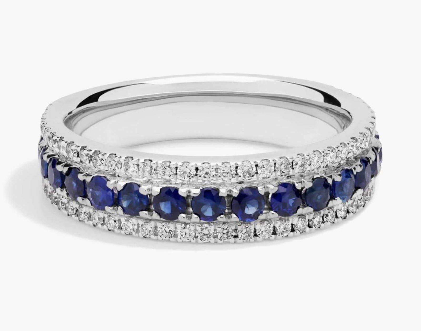 TRIPLE ROW SAPPHIRE AND DIAMOND RING IN 14K WHITE GOLD: A trail of velvety-blue sapphires, set between two rows of brilliant pave diamonds, completes this 14k white gold band.Note: Total Diamond Weight: Approx. 1/3 ct.