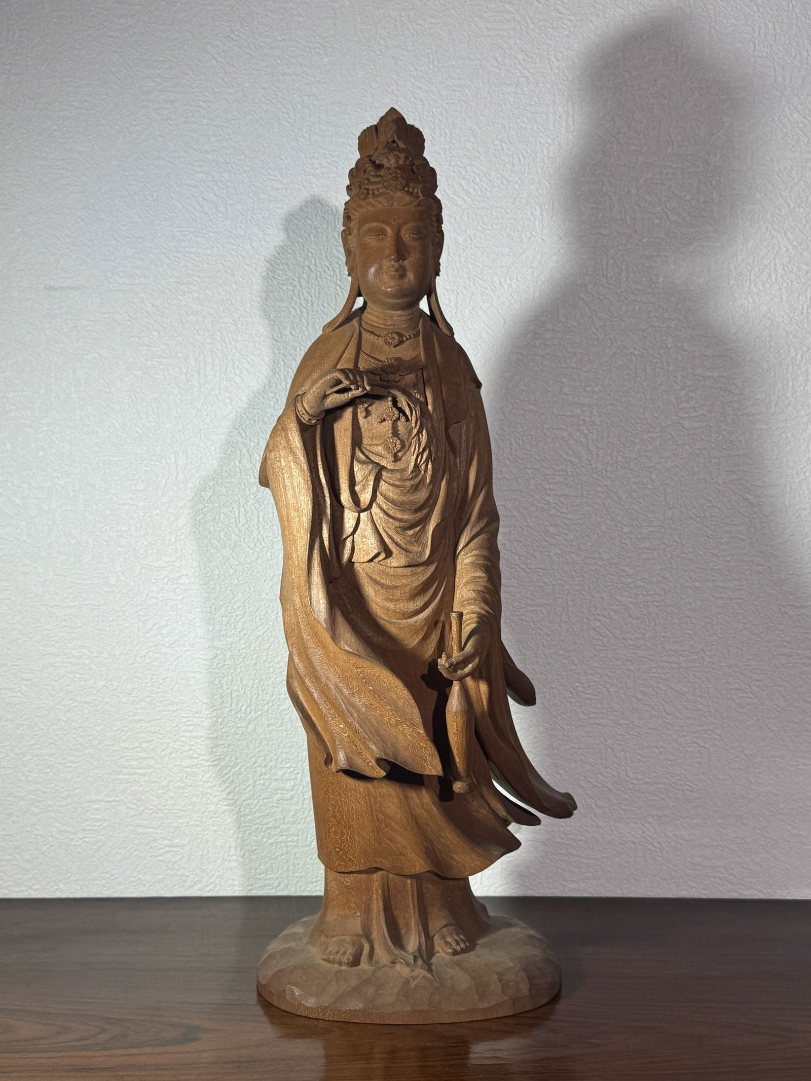 JAPANESE CARVED WOOD STANDING KUANYIN: Fine Japanese carved wood kuanyin of standing form, holding willow and ritual water vase, signed at bottom.Dimensions: Height: 18 in. (45.7 cm)Note: This item is in New York, where it can be shipped