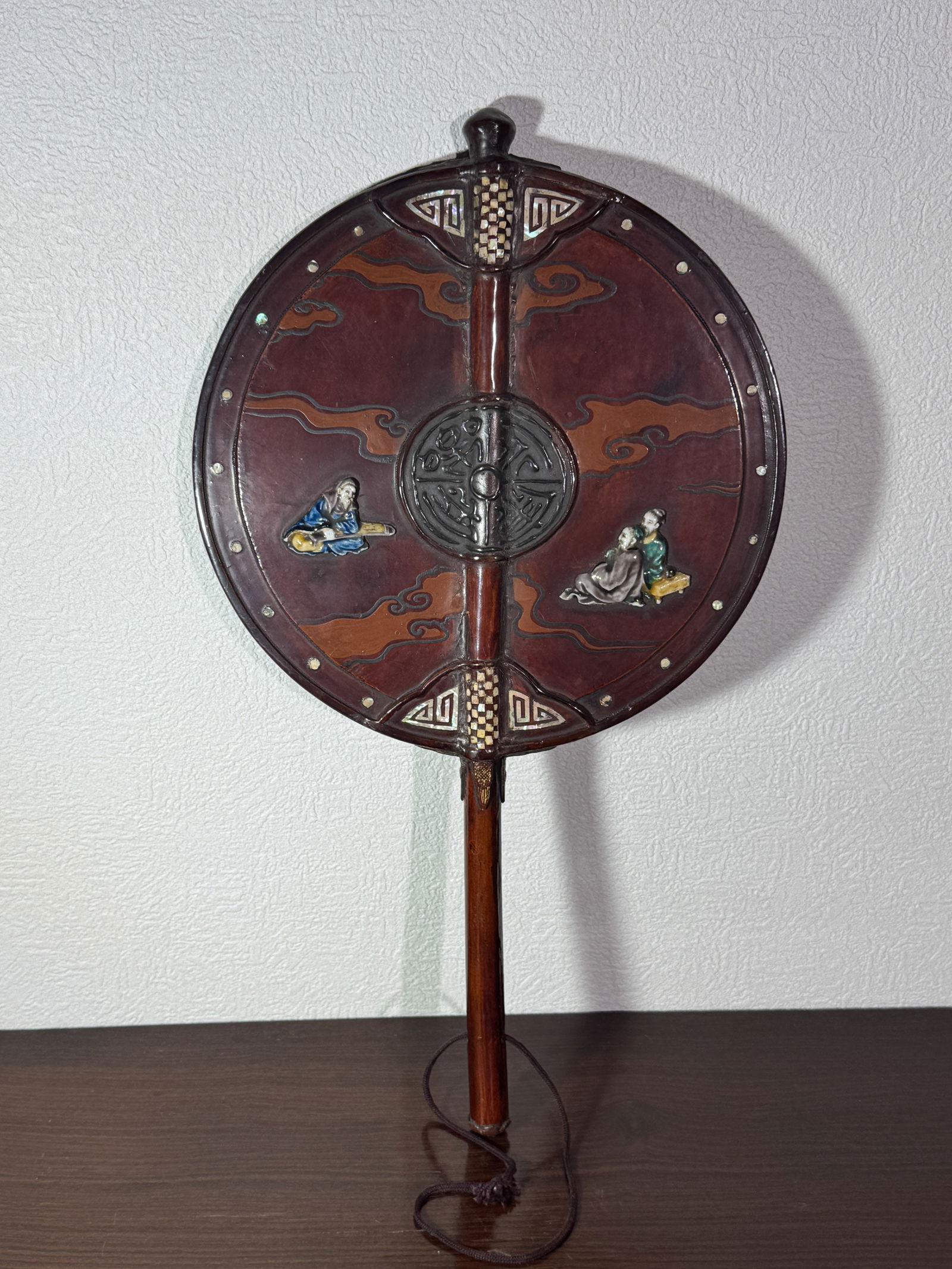 JAPANESE LACQUER FAN WITH PORCELAIN MOTHER-OF-PEARL CLOISONNE INLAYS: Japanese lacquered fan with various inlay, porcelain scholars, mother of pearl, cloisonne bird, Meiji period, ong. Dimensions: Length: 17 in. (43.2 cm); Width: 9.75 in. (24.8 cm) Note: This item is in
