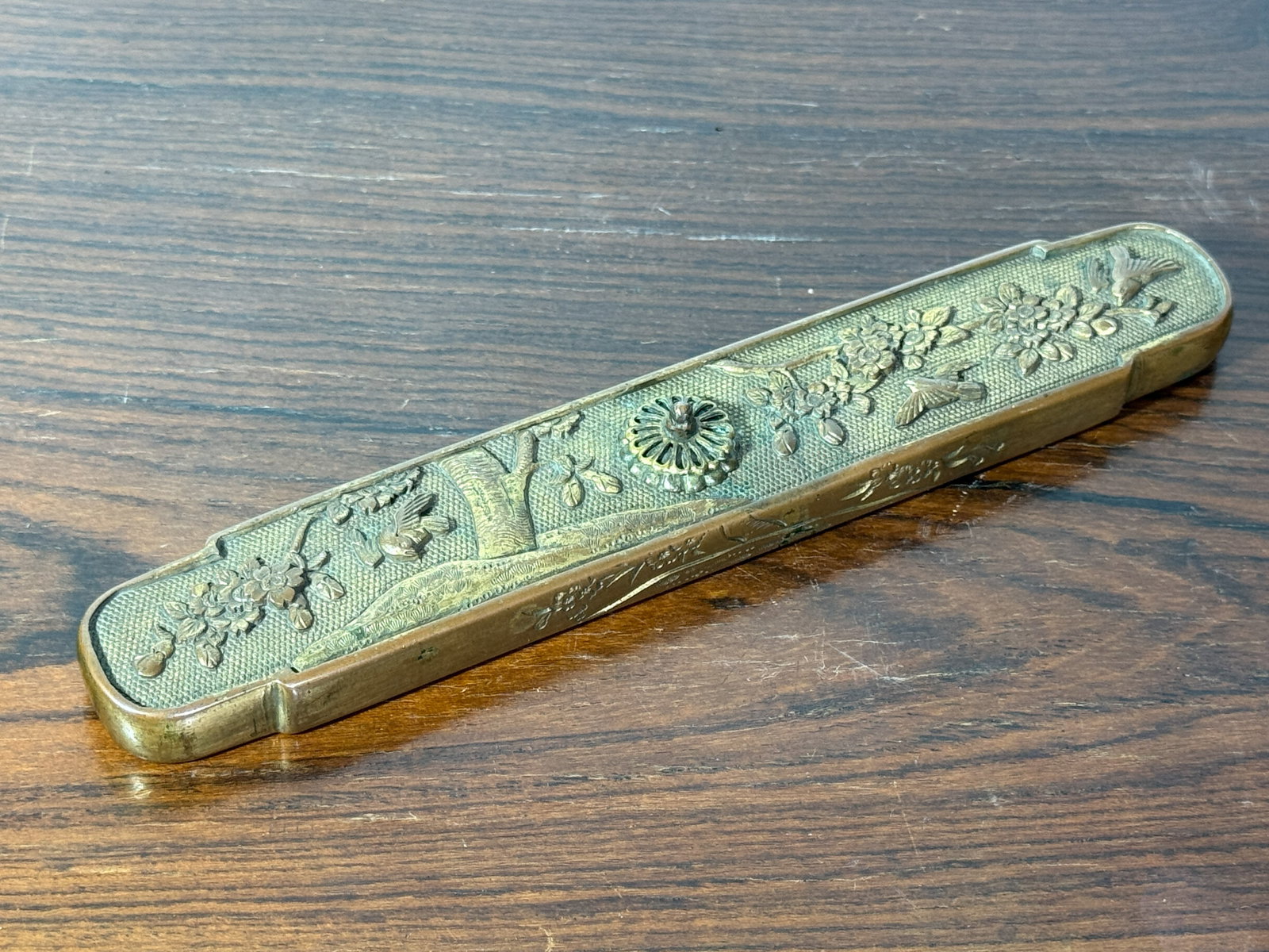 CHINESE GILT BRONZE SCHOLAR PAPER WEIGHT 18/19TH CEN: Chinese bronze scholar paper weight, gold tone, chased bird floral design. Dimensions: Length: 8 in. (20.3 cm) Note: This item is in New York, where it can be shipped from.