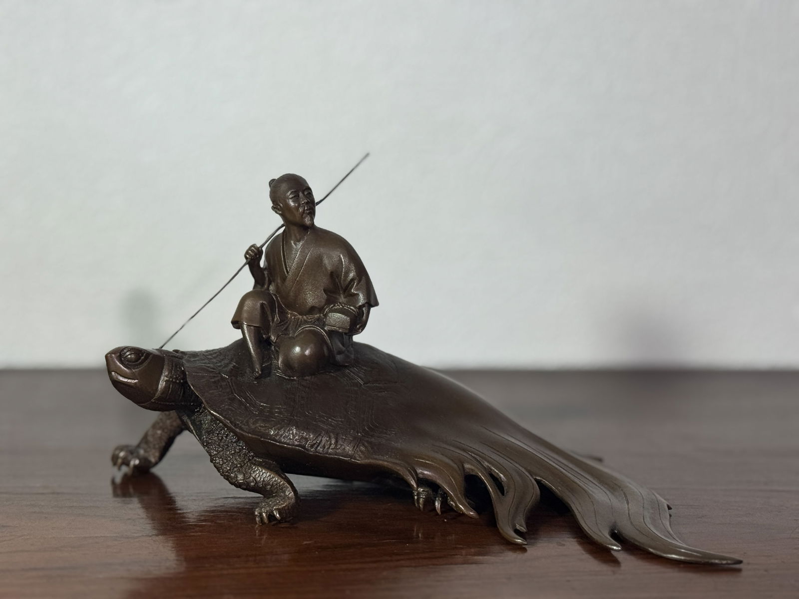 JAPANESE BRONZE OKIMONO OF SAGE ON LONGEVITY TURTLE: Japanese bronze okimono of sage riding turtle, signed. Dimensions: Length: 8 in. (20.3 cm); Height: 4.5 in. (11.4 cm) Note: This item is in New York, where it can be shipped from.